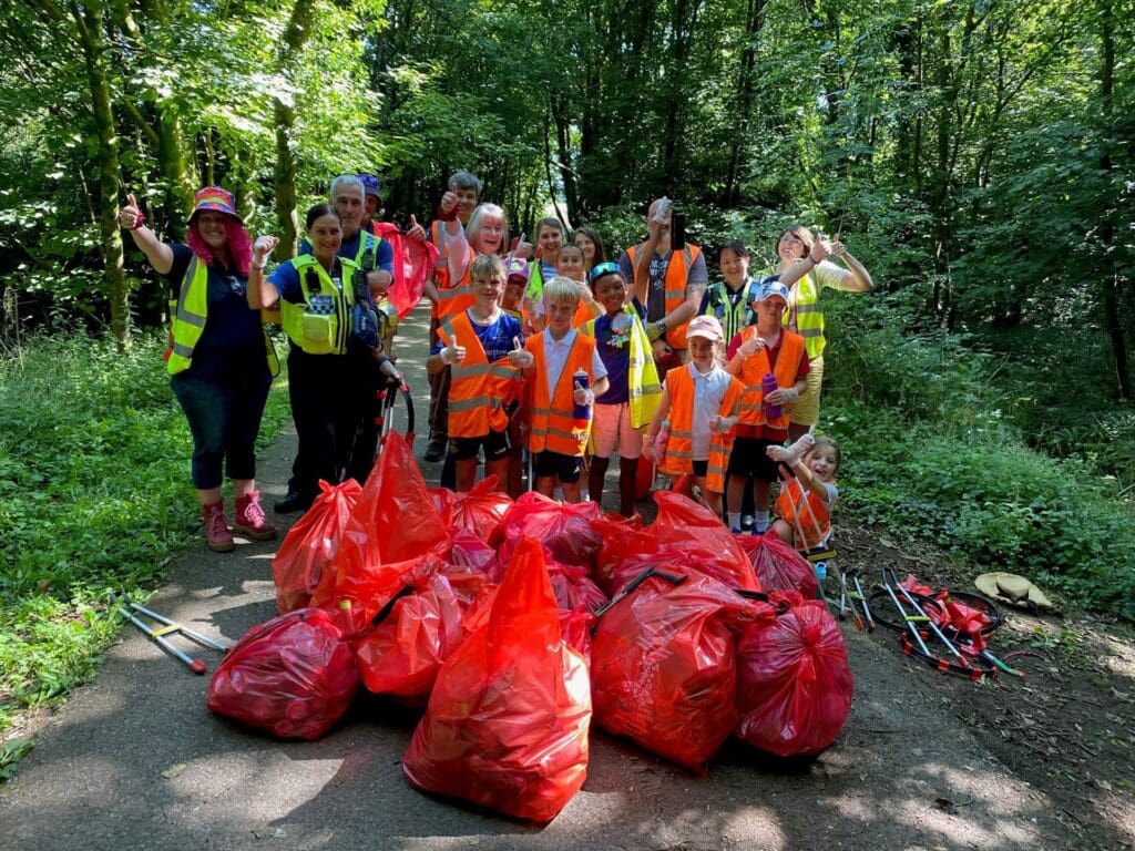 Pupils and community unite to clean woodland near new school site