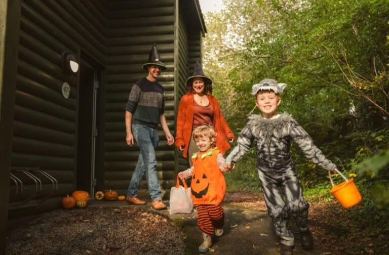 Welsh holiday resort launches month-long Halloween takeover Family in Halloween costumes outside a lodge at Bluestone National Park Resort
