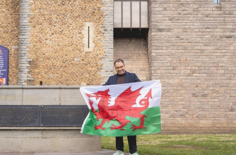 Final Rentals founder and CEO Ammar Akhtar holding a Welsh flag