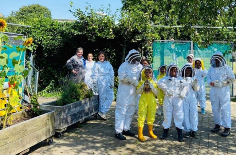 Nearly 600 events held across Wales during Adult Learners’ Week Beekeeping course participants in protective suits at the National Waterfront Museum in Swansea