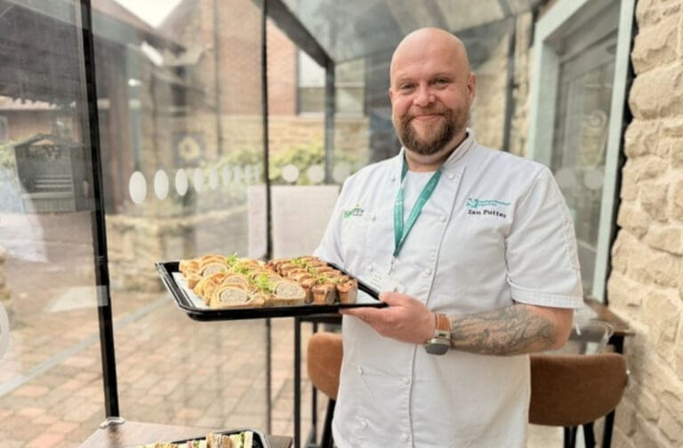 Caffi Cwtch Catering Manager Ian Futter holding a tray of food at Nightingale House Hospice
