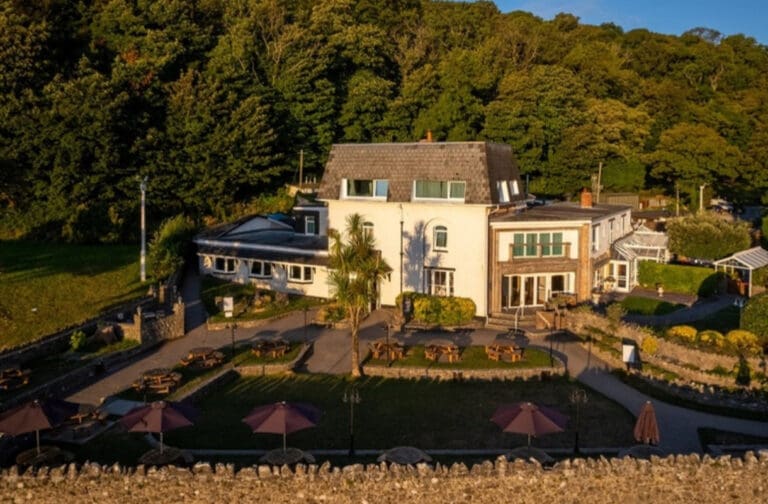 Historic Welsh seaside hotel opens its doors for exclusive private bookings Aerial view of Oxwich Bay Hotel and its grounds on the Gower Peninsula